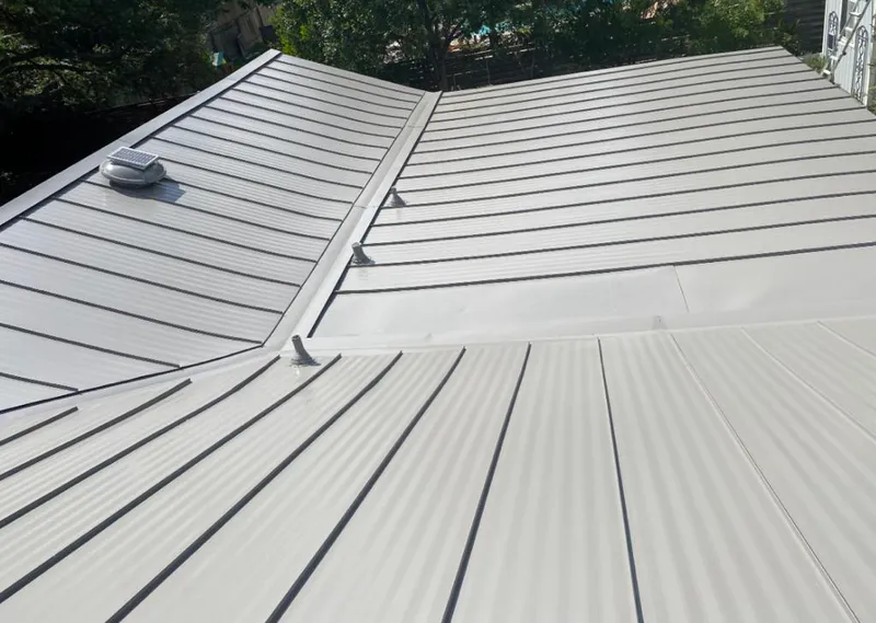 Solar attic fan installed on a metal roof for Roof Ventilation in Bay City